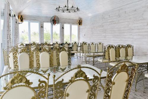 a row of chairs and tables in a room with windows at Viktoriya Family 2 Country complex in Kyiv