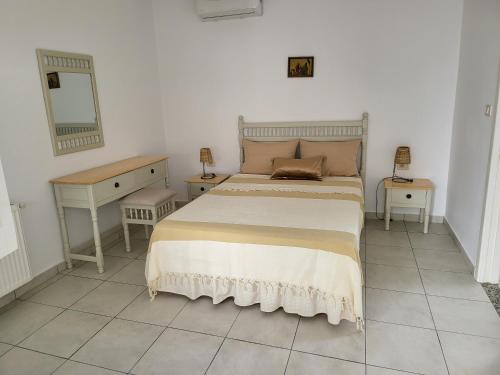 a bedroom with a bed and two tables and a mirror at Hotel Dar Al Madina in Mahdia
