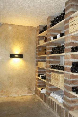 a wine cellar with a wall of wine bottles at Hotel Cervantes in Mendoza