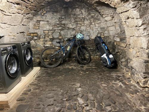 a bike parked next to a stone wall at Menstrie Castle Stay in Stirling