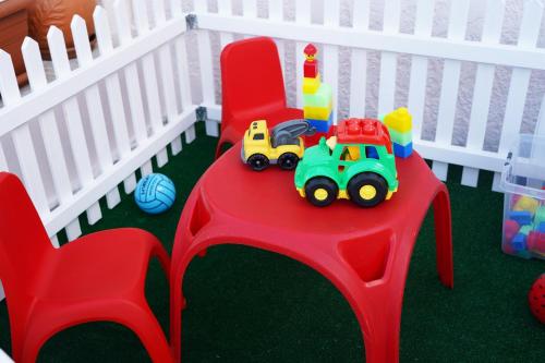 a toy truck on a red table with a toy fence at Villa Tzekos in Kendrokhórion
