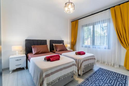 a bedroom with two beds and a window at Contemporary Luxury Villa in Yalıkavak Center in Bodrum City