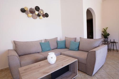 a living room with a couch and a table at Villa Tzekos in Kendrokhórion