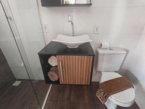 a small bathroom with a sink and a toilet at Marco Zero Containers 5 in Balneário Camboriú