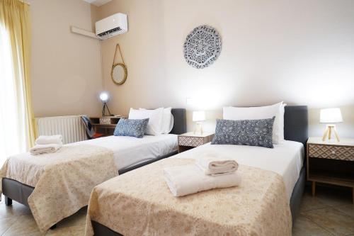 a hotel room with two beds with towels on them at Villa Tzekos in Kendrokhórion