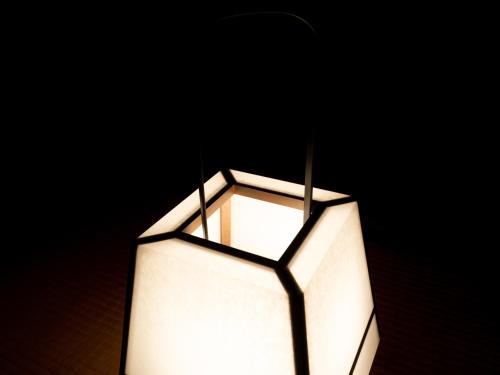 a white lamp with two sticks in it at SUKIYA-zukuri Suehiro in Hida