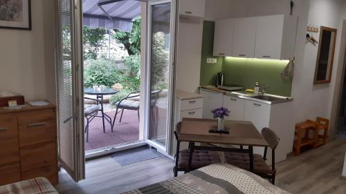 een keuken met een tafel en een keuken met een deur naar een patio bij BIKE apartments 1 in Hodruša