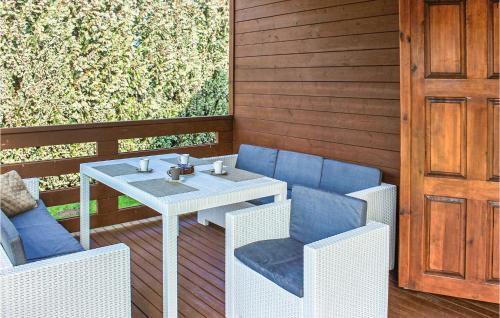 a patio with a table and chairs and a door at Amazing Home In Stepnica With Kitchen in Stepnica