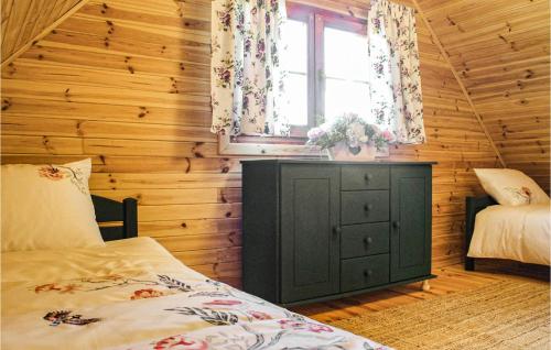 a bedroom with a green cabinet and a window at Amazing Home In Stepnica With Kitchen in Stepnica
