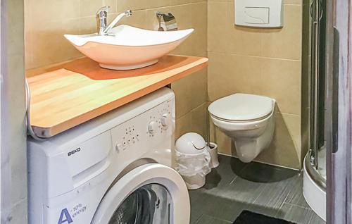 a bathroom with a sink and a washing machine at Lovely Apartment In Bobolin With Kitchen in Bobolin