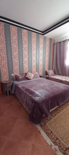 a bedroom with a large bed in a room at BananaHouse in Tamri