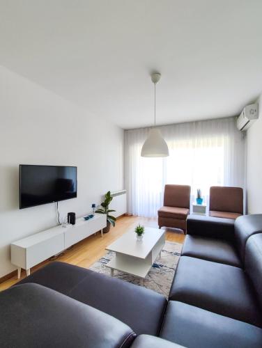 a living room with a couch and a tv at Sleep & Rest in Skopje