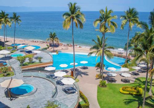 an aerial view of a resort with a pool and the ocean at Sunset Plaza Beach Resort Puerto Vallarta All Inclusive in Puerto Vallarta