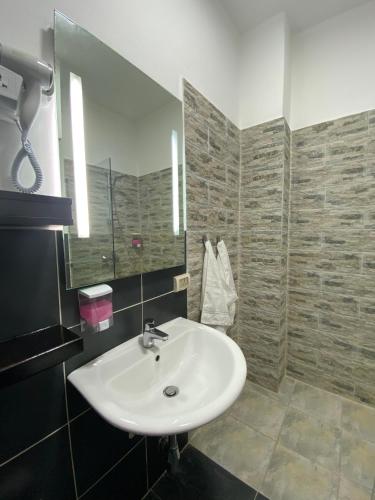 a bathroom with a white sink and a mirror at Lemon Tree Residence in Amman