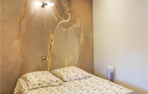 a bed in a room with a wall at Amazing Apartment In Publier With Internet And 1 Bedrooms in Publier