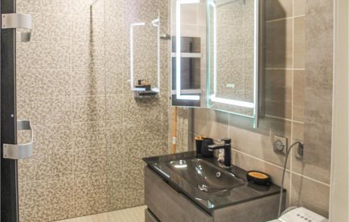 a bathroom with a sink and a mirror at Amazing Apartment In Publier With Internet And 1 Bedrooms in Publier