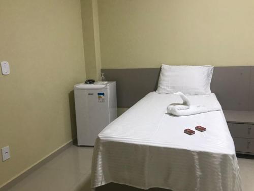 Pousada BarbacoaR في بارنايبا: غرفة مستشفى مع سرير عليها منشفة