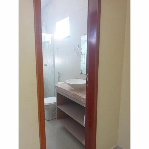 a bathroom with a sink and a toilet at Pousada BarbacoaR in Parnaíba