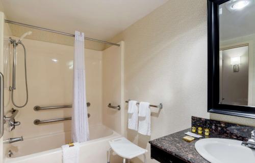 a bathroom with a tub and a sink and a shower at BEST WESTERN PLUS Inn at Valley View in Roanoke