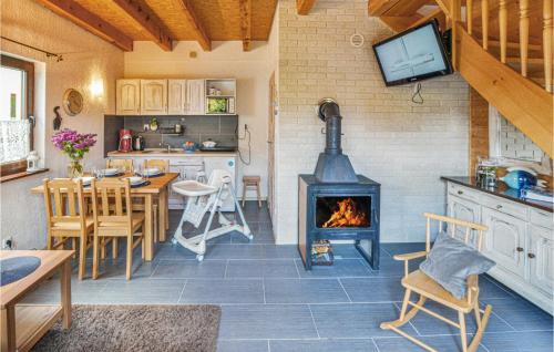 a kitchen with a fireplace and a table and chairs at Awesome Apartment In Bobolin With Wifi in Bobolin
