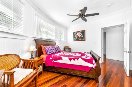 a bedroom with a bed and a ceiling fan at Diamond Head Ohana 30 plus Day Rental in Honolulu