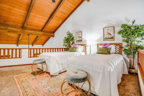 a bedroom with two beds and a wooden ceiling at Waikomo Stream Villas 132 in Koloa
