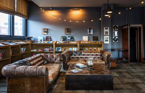 a living room with couches and a coffee table at The Iron Horse Hotel in Milwaukee