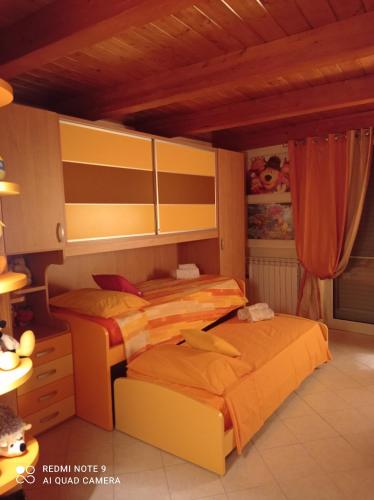 una camera con 2 letti e un soffitto in legno di IL MULINO Appartamento Itri centro 150 m2 con ampio terrazzo completo di tutti i comfort a Itri