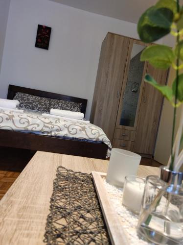 a room with a bed and a table with a mirror at Banjica 2 in Voždovac