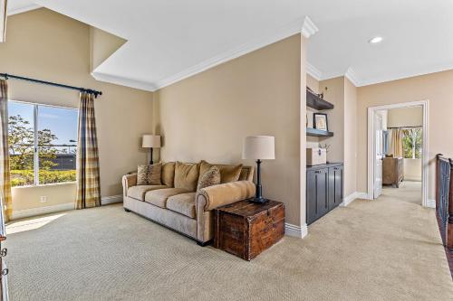 a living room with a couch and a table at La Paloma in Dana Point