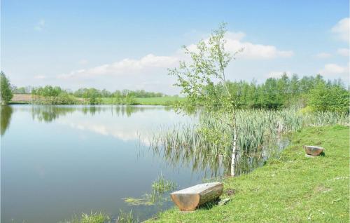 a lake with two rocks on the side of it at One-Bedroom Apartment In Borcz in Borcz