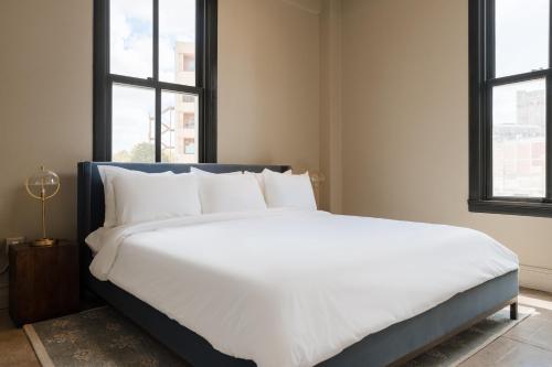 a large white bed in a room with windows at Sonder The Atlee in San Antonio