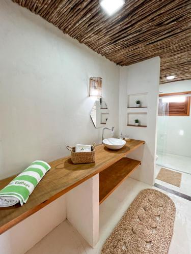 a bathroom with a counter with a sink and a shower at Let Village in Amontada