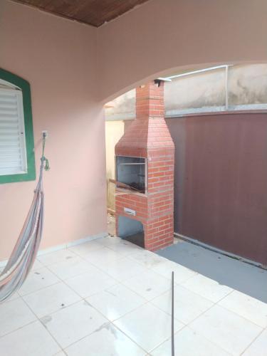 a room with a brick fireplace in a house at Casa Bela in Bonito