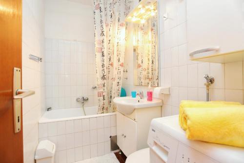 a bathroom with a sink and a toilet and a tub at Apartments with WiFi Split - 17706 in Split