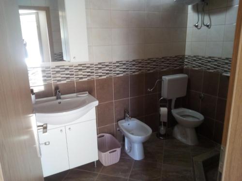 a bathroom with a sink and a toilet at Apartment Silba 17603a in Silba