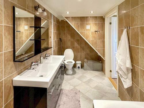 a bathroom with a sink and a toilet at Two-Bedroom Holiday home in Laupstad 4 in Vestpollen