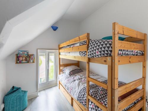 a bedroom with bunk beds in a attic at Nice holiday home in Isigny sur Mer with garden in Isigny-sur-Mer