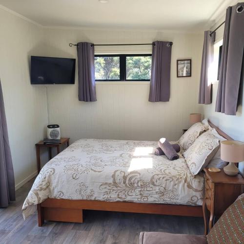 a bedroom with a bed with a teddy bear on it at Wild Days Accommodation in Palm Beach