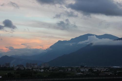 a view of a city and mountains at sunset at Sunny Breeze Garden Homestay in Jiali
