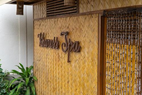 a sign on the side of a building with a cross at Asia Grand View Hotel in Coron