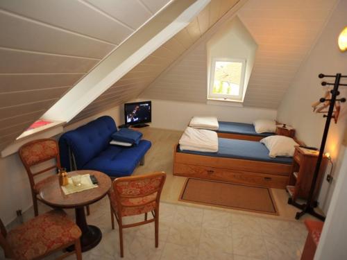 a bedroom with a bed and a couch and a table at Apartments by the sea Sutivan, Brac - 17796 in Sutivan