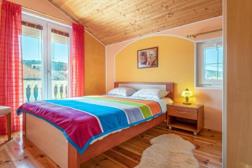 a bedroom with a bed and a window at Apartments by the sea Kraj, Pasman - 17783 in Tkon