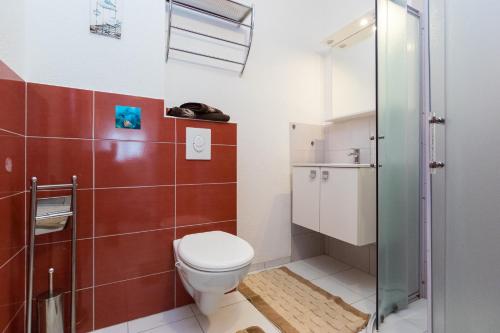a bathroom with a toilet and a glass shower at Apartments and rooms with parking space Grebastica, Sibenik - 17831 in Šibenik