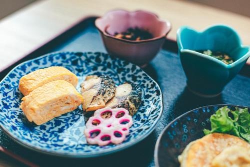 a blue plate of food on a table at Kyonoyado Kiyomizu Gojo Kuretakeso in Kyoto