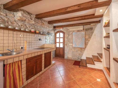 a large kitchen with a sink and a staircase at Family friendly house with a swimming pool Zagore, Opatija - 17924 in Mošćenička Draga