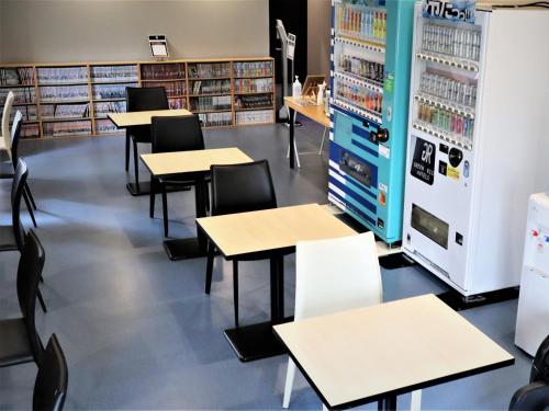 a classroom with tables and chairs in a library at Green Rich Hotel & Capsule Naha - Artificial hot spring Futamata Yunohana in Naha