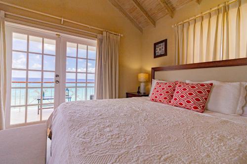 a bedroom with a bed with a view of the ocean at Bianca Bay 3 Bedroom West Coast Beach Front Villa in Saint James