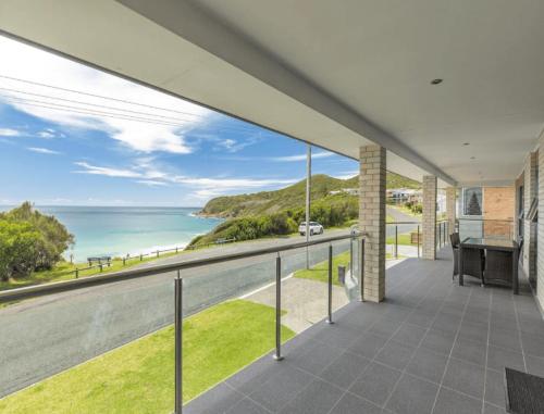 a view of the ocean from the balcony of a house at Burgess Beach 1 in Forster