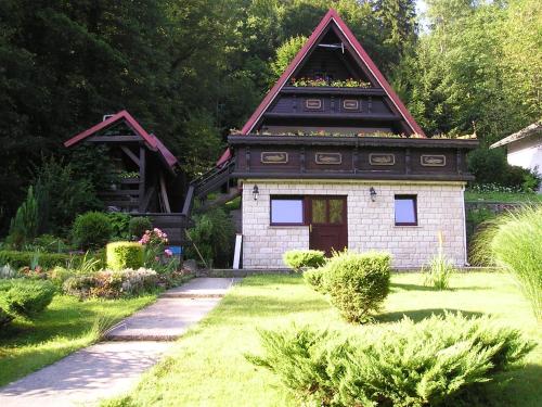 Holiday house with a parking space Gusti Laz, Gorski kotar - 17993 في ديلنايس: منزل قديم وامامه حديقة